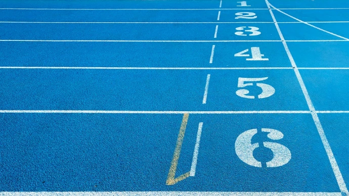 a blue running track with white numbers on it